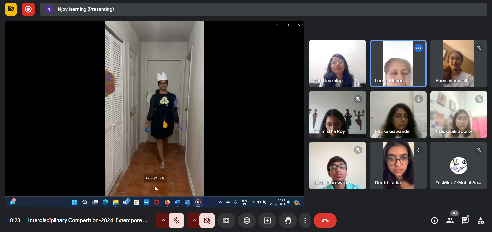 A group of diverse young professionals happily collaborating around a laptop indoors.